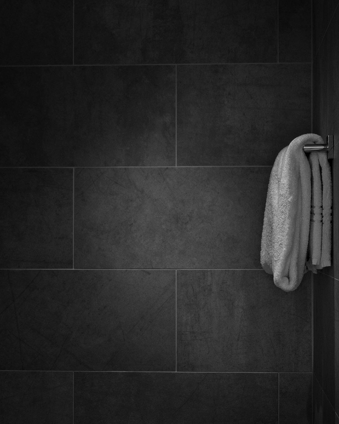 Misted glass and water droplets in a calm, modern bathroom setting.